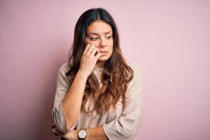 concerned woman on pink bacground