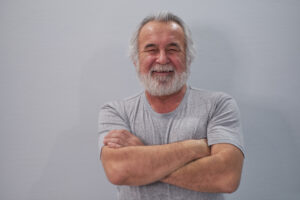 Healthy happy older man smiling arms crossed