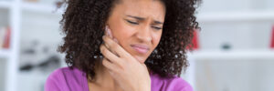 pretty african american young woman have a toothache